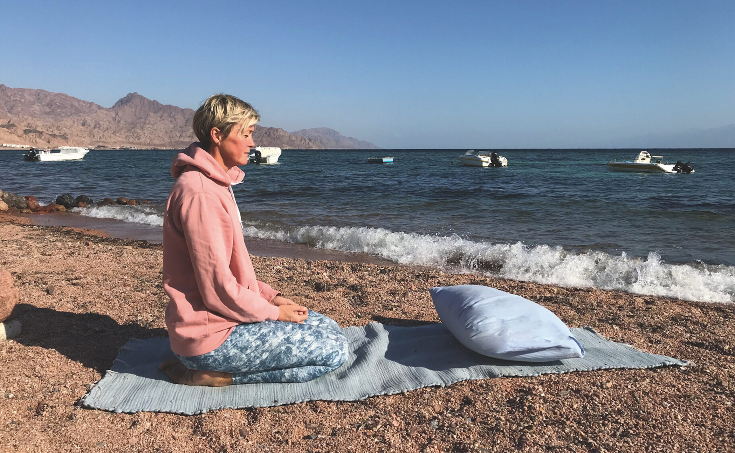 Yin Yoga in Dahab: Nina Raem am Roten Meer im Fersensitz sitzend